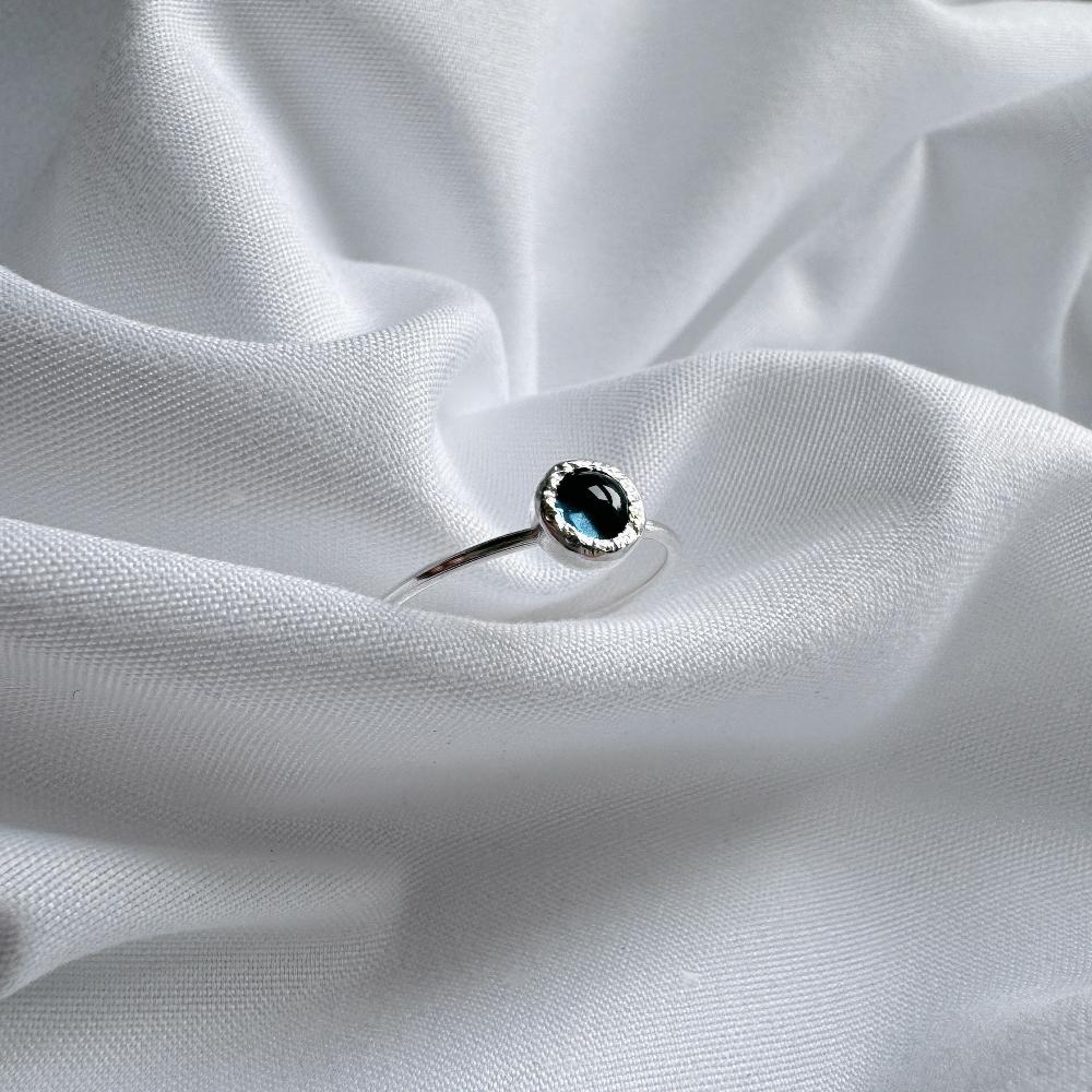 London Blue topaz stone set in silver on a dainty silver band