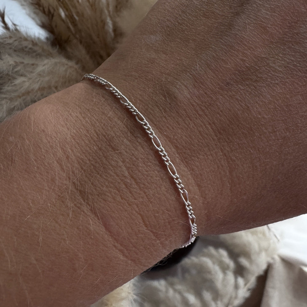 Dainty Silver bracelet on a wrist with a soft background