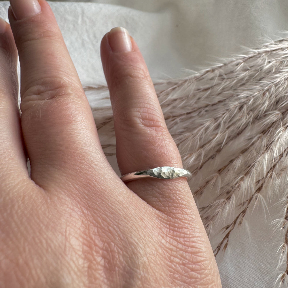 silver hammered mini signet ring worn on the little finger