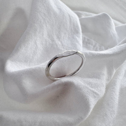silver hammered mini signet ring on a white fabric 