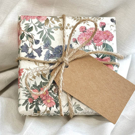 a present wrapped with Floral gift wrap and brown twine wrapped around and tied in a bow with a brown paper gift tag