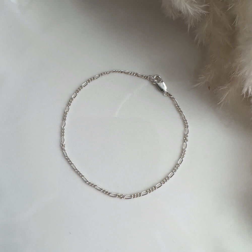 Silver chain bracelet with a soft white background