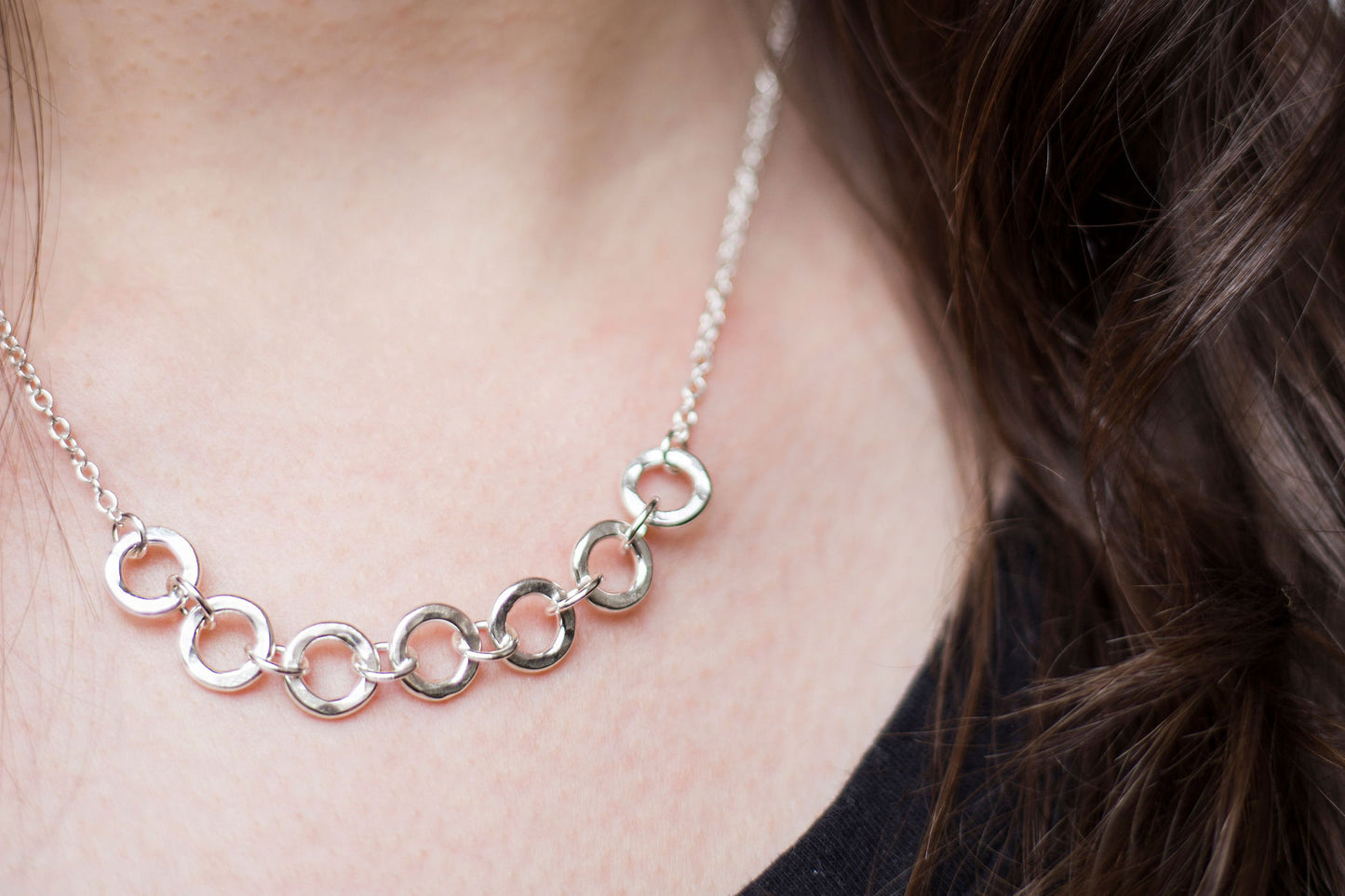 seven silver links necklace worn with a black t-shirt, handmade by Anna Calvert Jewellery