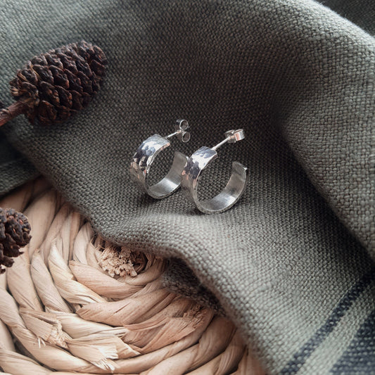 Chunky Handmade Silver Hoops Earrings on green fabric