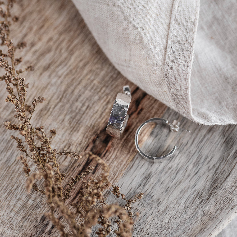 Chunky 6mm wide Silver Hoops Earrings with a hammered finish on a wooden surface 